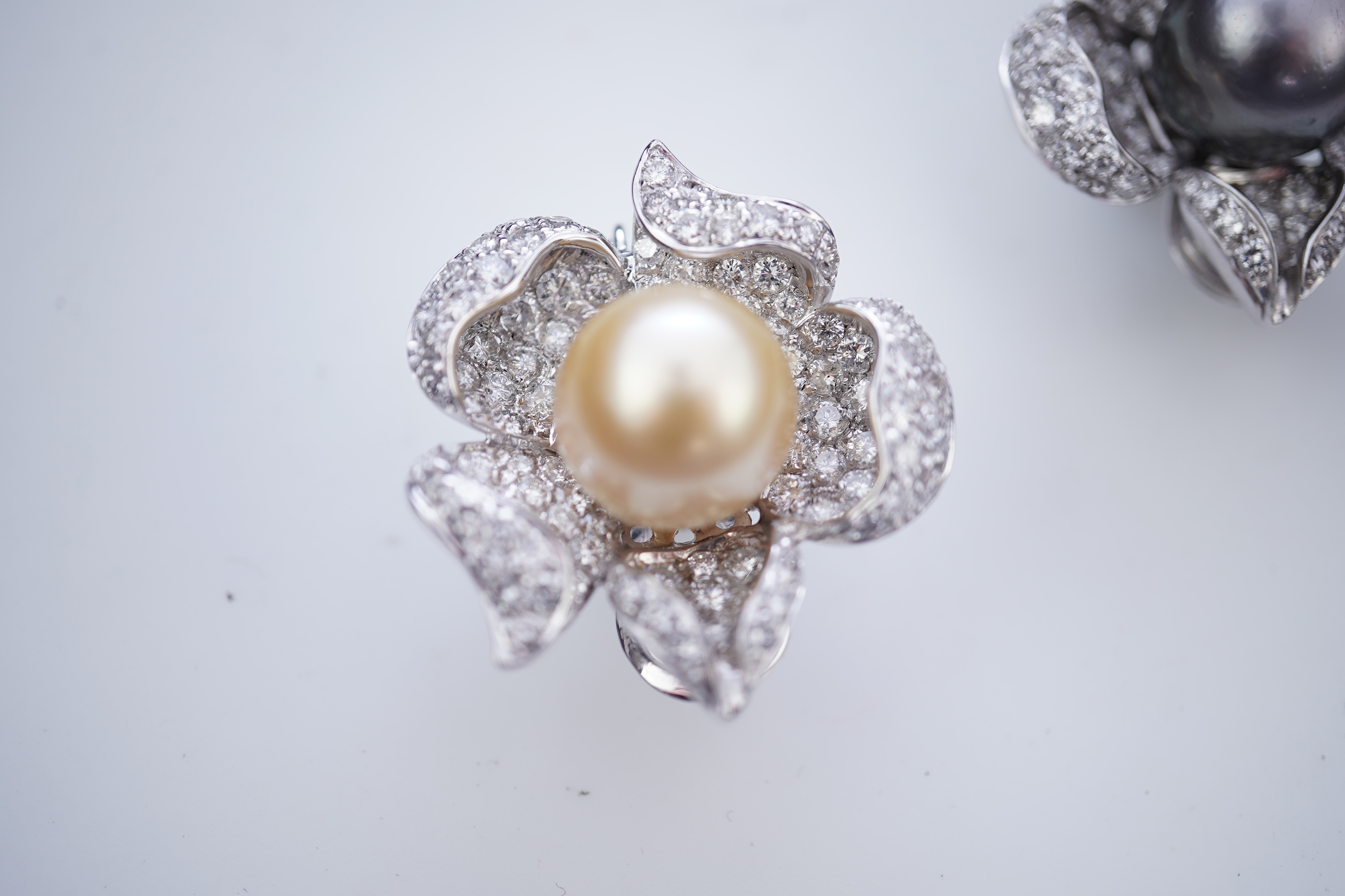 A pair of cultured pearl and diamond ear clips